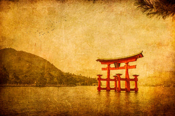 A red torii gate rising from the water with distant mountains and birds in flight, introducing a feature blog article that presents an interview with Andrew Paranavitana.